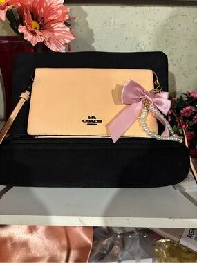 Coach Pebbled Leather Crossbody Clutch in Peach with Pink Bow Charm see pix